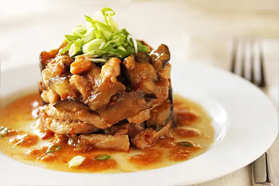 A plate of food with meat and sauce on it.