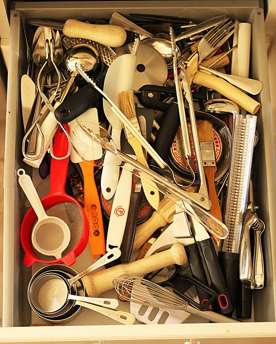 A drawer full of kitchen utensils and cooking implements.