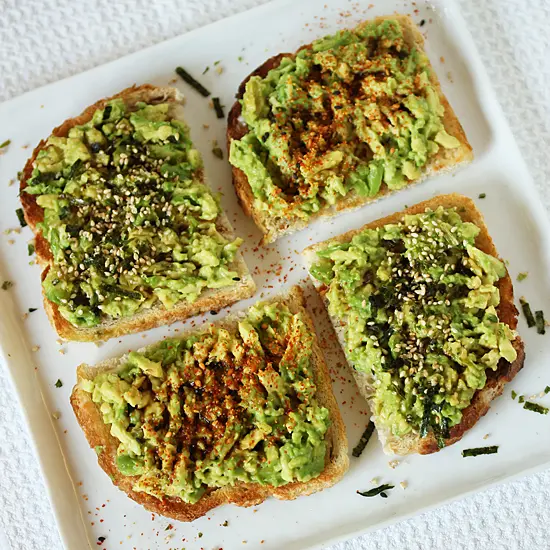 A white plate topped with four pieces of bread.