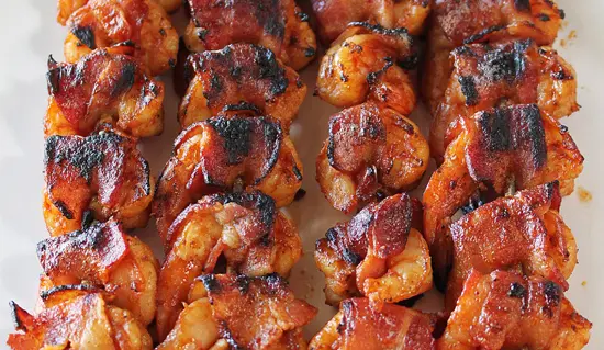 A close up of some bacon wrapped shrimp