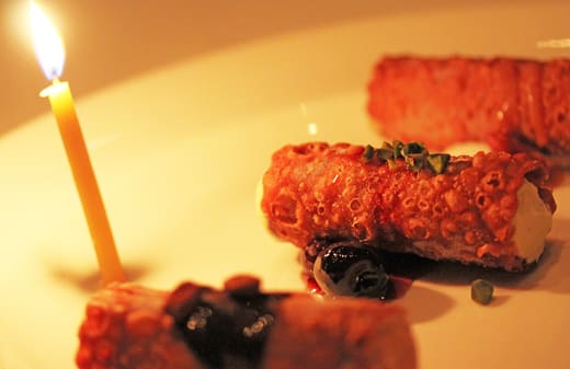 A plate of food with olives and meat.