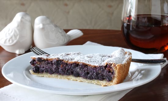 A slice of pie on top of a white plate.