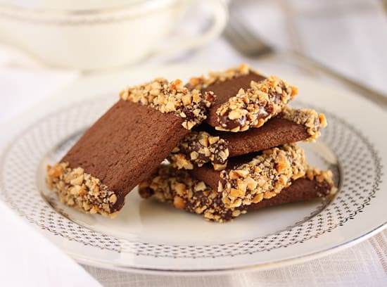 A plate with some chocolate and nuts on it