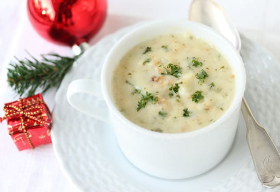 A bowl of soup on top of a white plate.