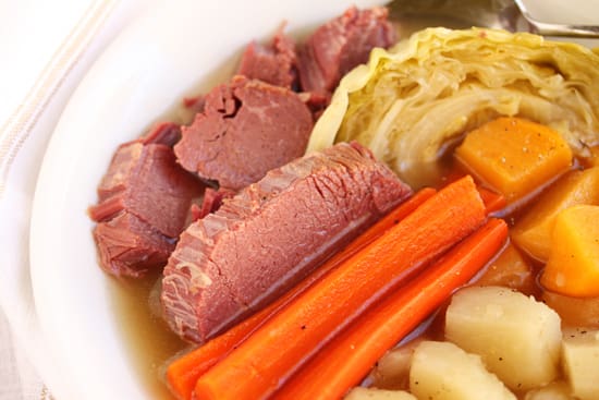 A bowl of corned beef, carrots and potatoes.