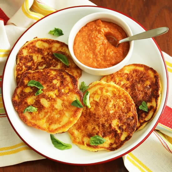A plate of food with some pancakes and sauce.