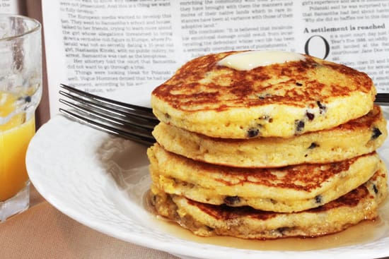 A stack of pancakes on top of a white plate.