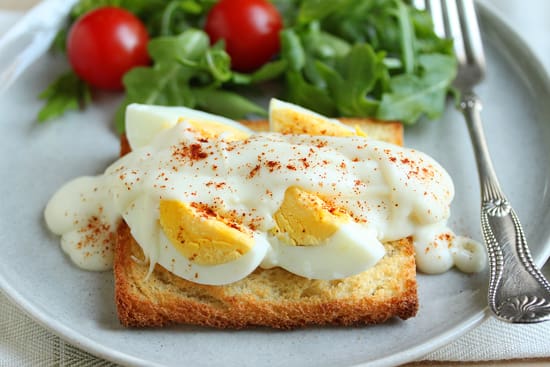 A plate of food with eggs on top