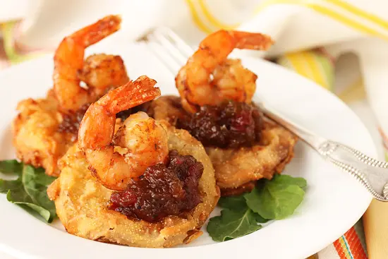 A plate of food with shrimp and rice patties.