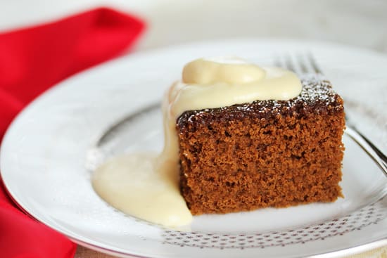 A piece of cake with white frosting on top.