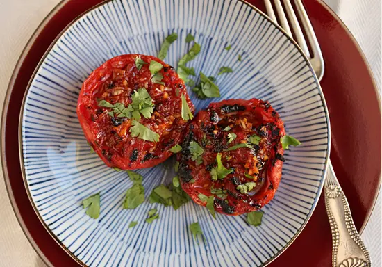 A plate with two tomatoes on it