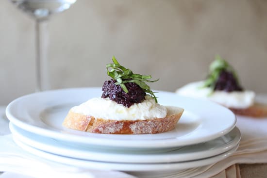 A piece of bread with cream cheese and jam on top.