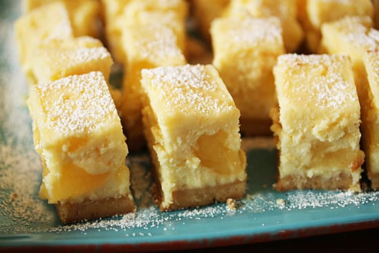 A close up of some lemon bars on a plate
