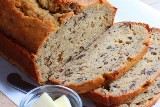 A loaf of bread with butter on the side.
