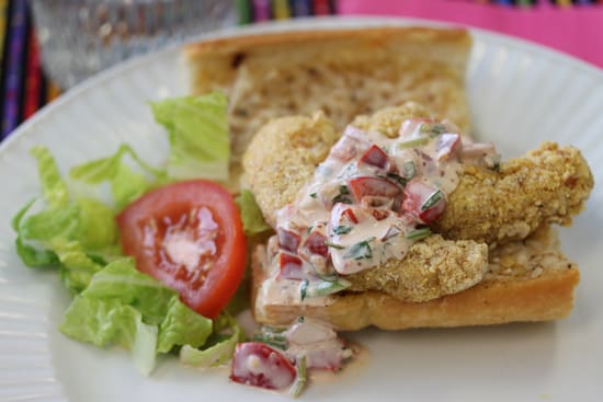 A sandwich with meat and salad on it.