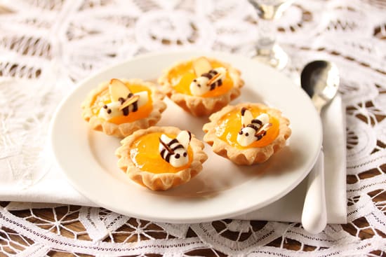 A plate with four small pastries on it.