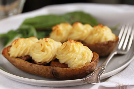A plate of food with potatoes and cheese on it.