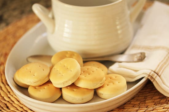 A plate of biscuits and a cup on the table.