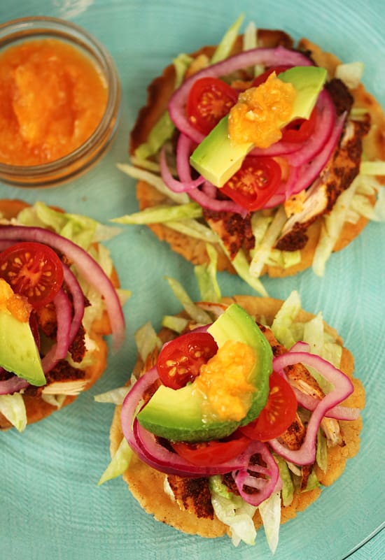 A close up of three sandwiches on top of a plate