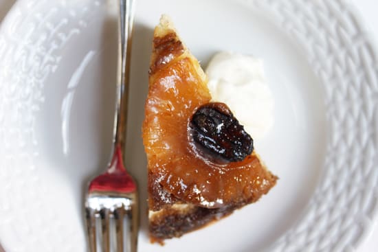 A piece of cake and fork on a plate.