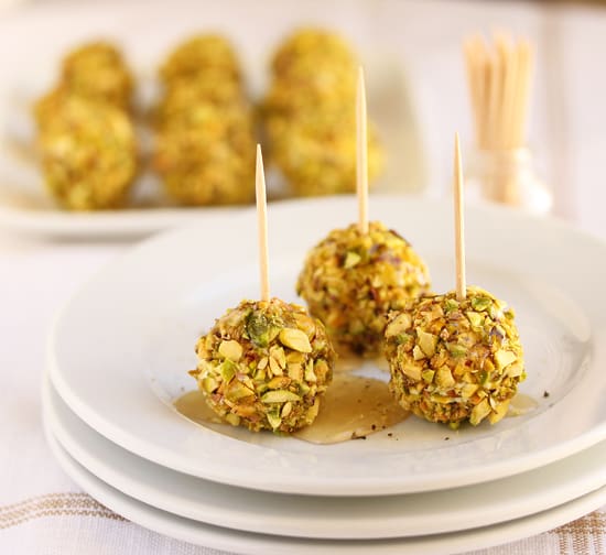A white plate topped with three balls of food.