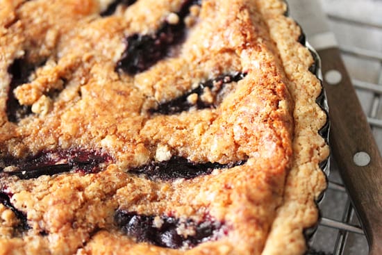 A close up of a pie with blueberries on top
