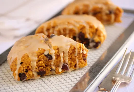 A close up of three cookies on a pan