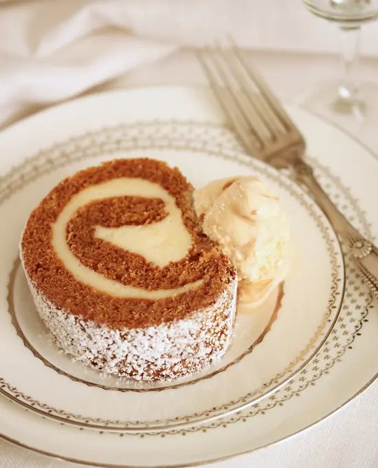 A small cake with cream on top of it.