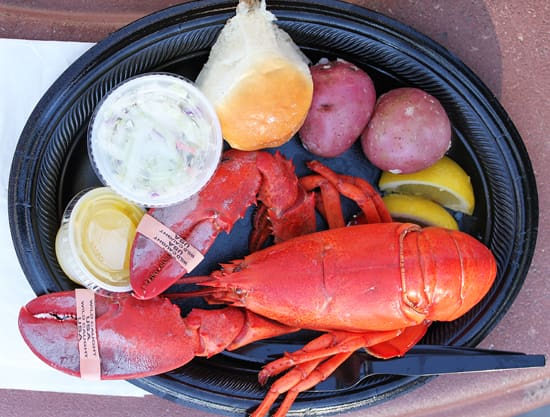 A plate of lobster, fruit and sauce.