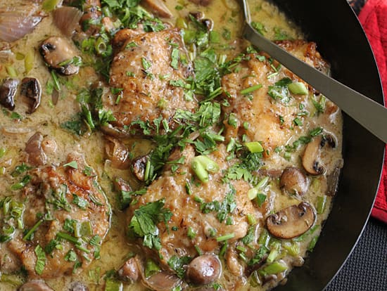 A pan of food with mushrooms and meat.