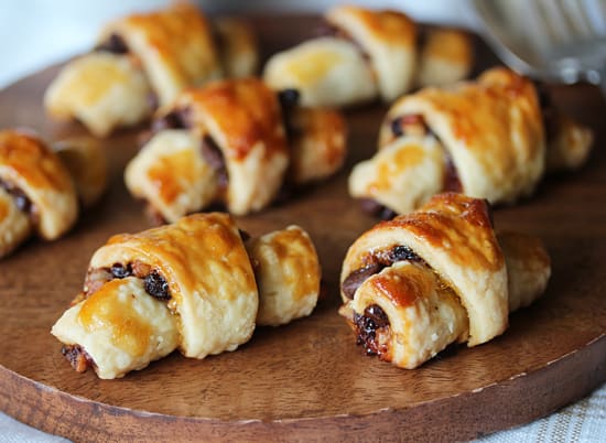 A wooden board with some pastries on it