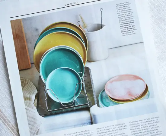A magazine photo of plates and bowls on a rack.