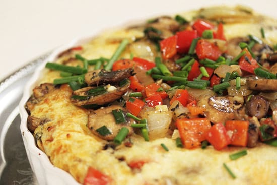 A close up of an omelet with vegetables