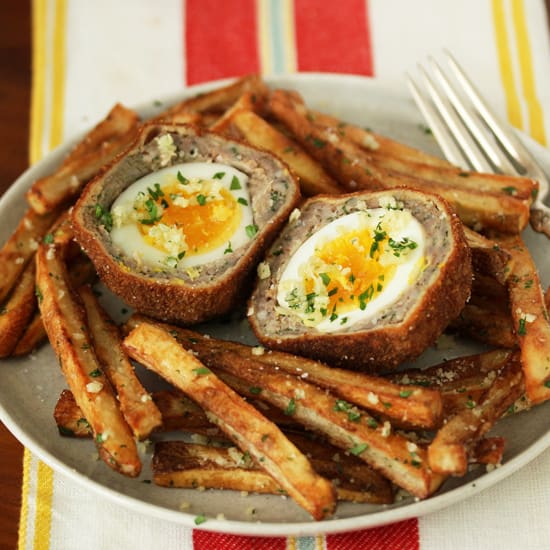 A plate of food with egg in meat and potatoes.