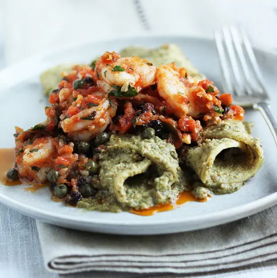 A plate of food with pasta and sauce on it.