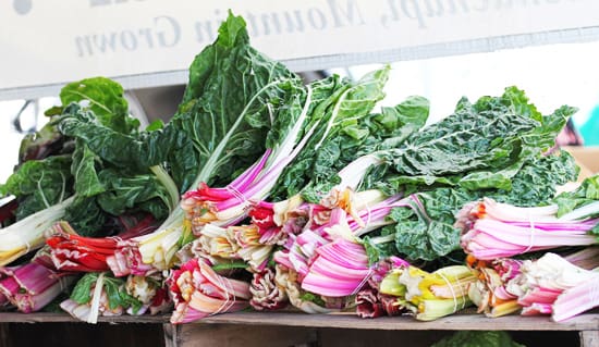 A pile of fresh vegetables sitting on top of each other.