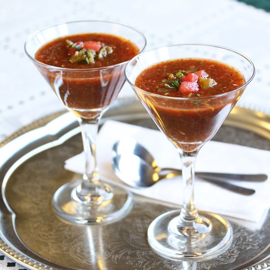 Two glasses of soup on a silver tray.