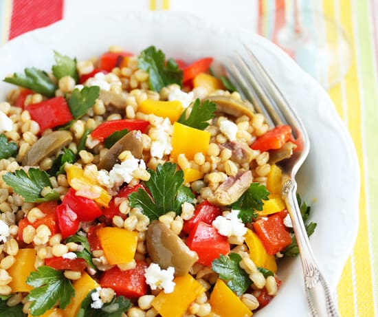 A bowl of food with vegetables and feta cheese.