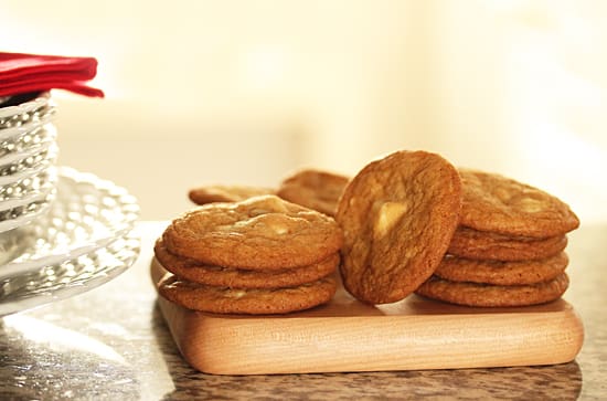 A pile of cookies sitting on top of a wooden board.
