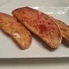 A white plate topped with three pieces of bread.