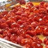 A pan of cherry pie covered in cherries.