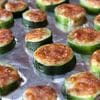A bunch of zucchini sitting on top of foil.