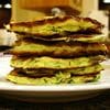 A stack of pancakes on top of a white plate.