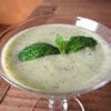 A bowl of broccoli soup with mint garnish.