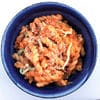 A bowl of pasta with meat and sauce.