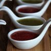 A row of bowls filled with different sauces.