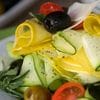 A salad with cucumber, tomato and other vegetables.