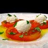 A plate of food with tomatoes and cheese.