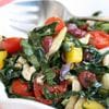A salad with tomatoes, lettuce and other vegetables.