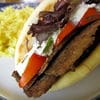 A sandwich with meat and vegetables on it.
